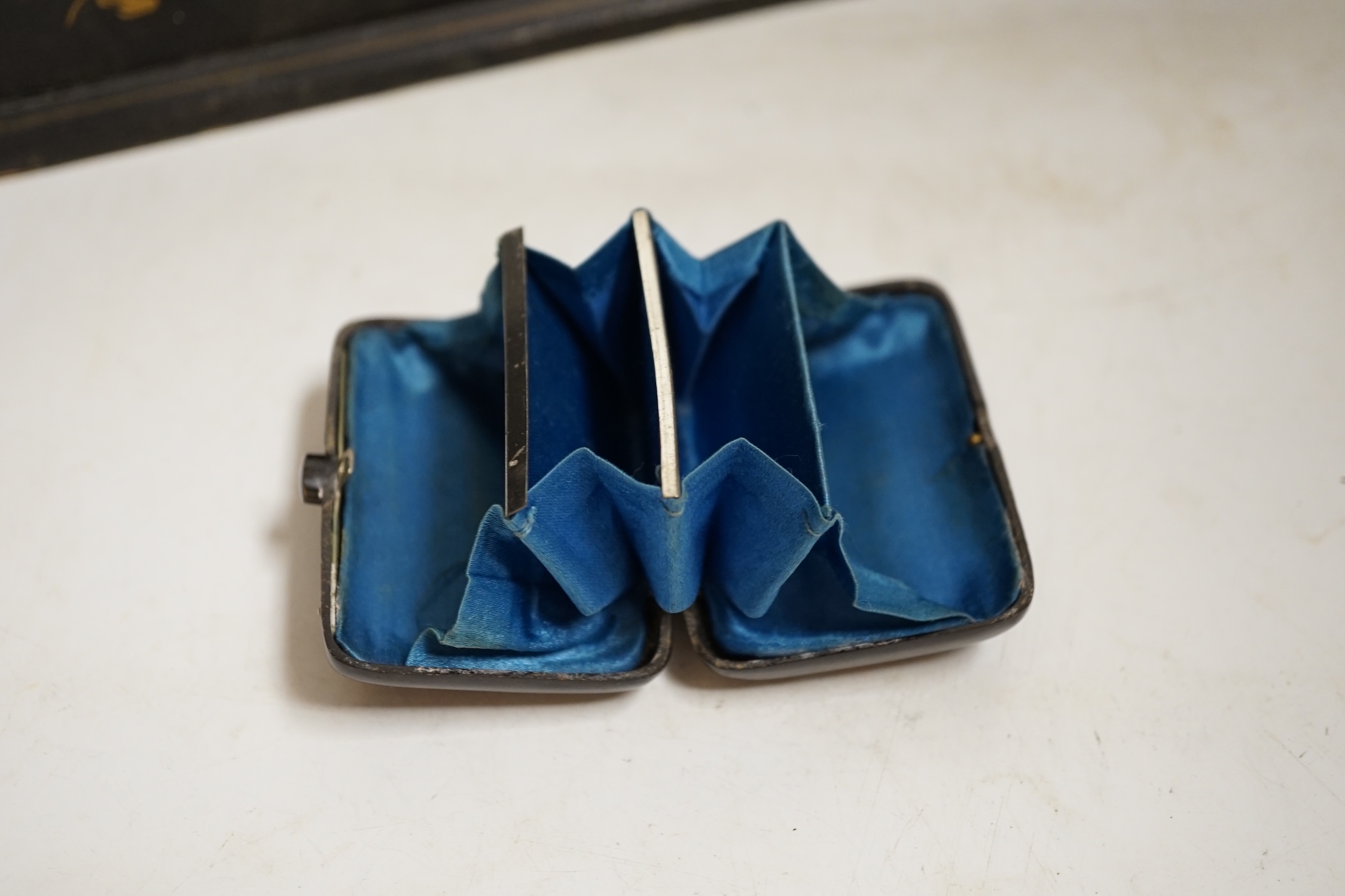 A French japanned papier maché glove box together with a tortoiseshell card case inlaid with white and yellow metal, largest 30cm wide. Condition- fair